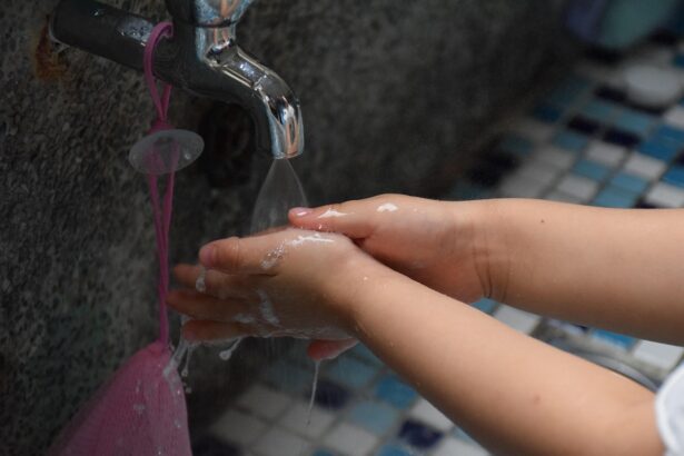 Child washing hands with soap at a kitchen sink for hygiene protection