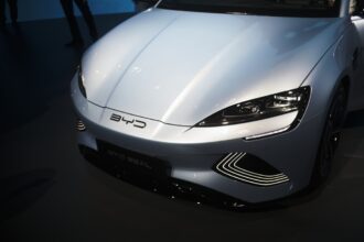 Visitors at the Munich IAA 2025 in front of large BYD and Xpeng stands showcasing electric vehicles