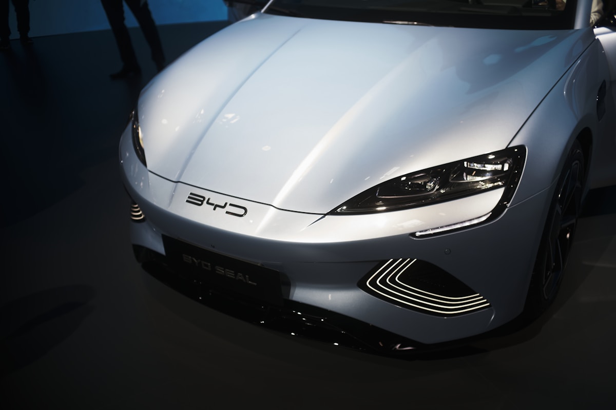 Visitors at the Munich IAA 2025 in front of large BYD and Xpeng stands showcasing electric vehicles