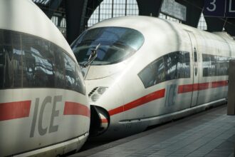 High-speed ICE train departing Munich Central Station under new 2026 timetable