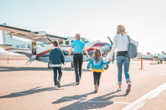 German family with children at airport preparing for summer holiday trip