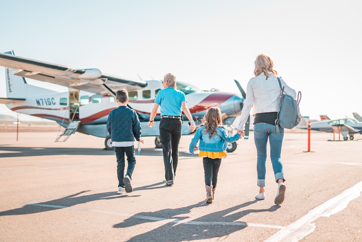 German family with children at airport preparing for summer holiday trip