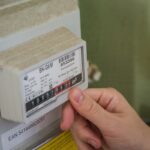 German household reviewing gas meter and utility bills
