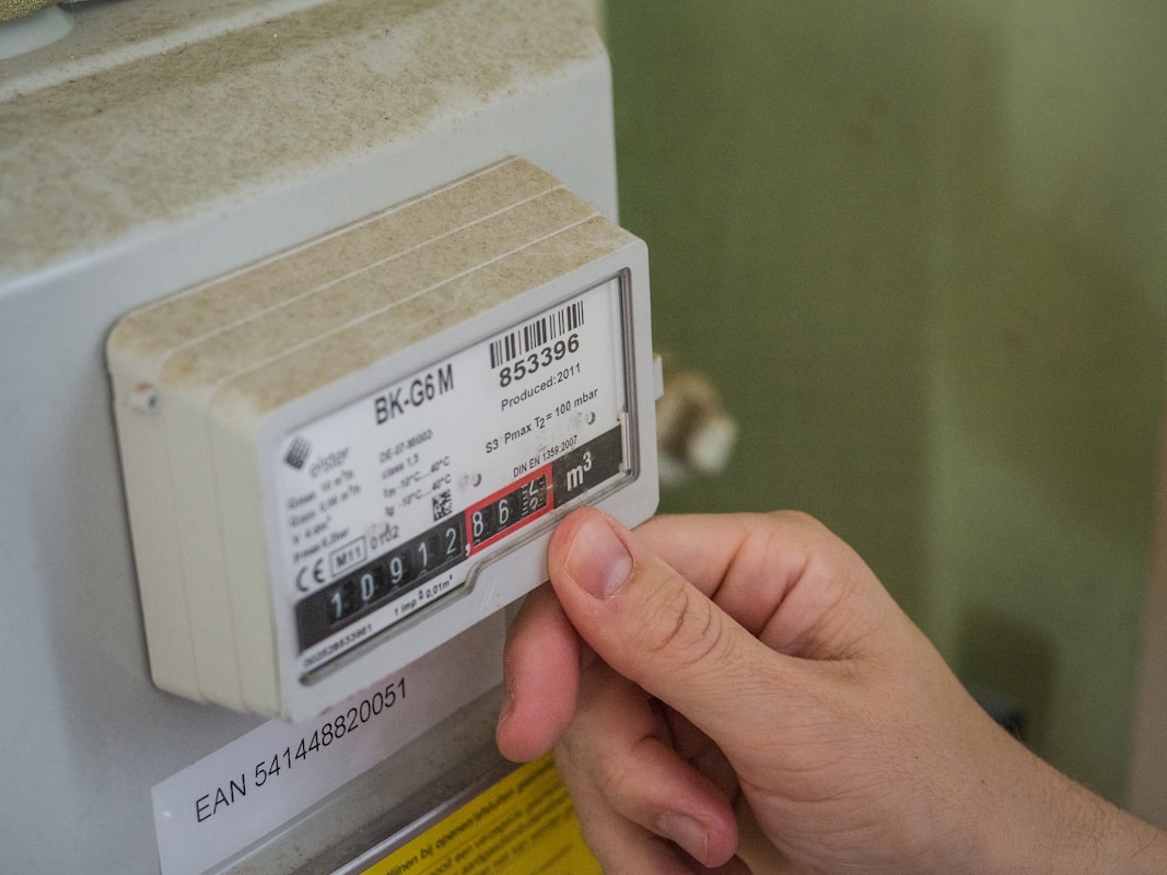 German household reviewing gas meter and utility bills