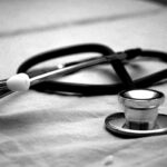 German statutory health insurance card placed next to a stethoscope