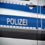 Federal Police officers patrol Munich Central Station during Oktoberfest with passengers nearby