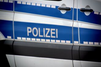 Federal Police officers patrol Munich Central Station during Oktoberfest with passengers nearby