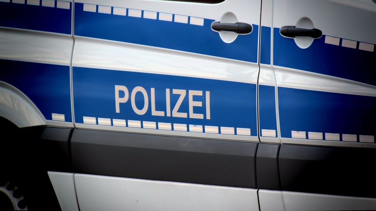 Federal Police officers patrol Munich Central Station during Oktoberfest with passengers nearby