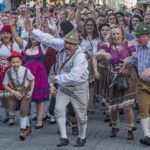 Visitors at Munich Oktoberfest fanning themselves in crowded tent during record heat