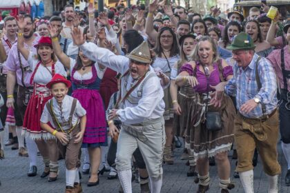 Visitors at Munich Oktoberfest fanning themselves in crowded tent during record heat