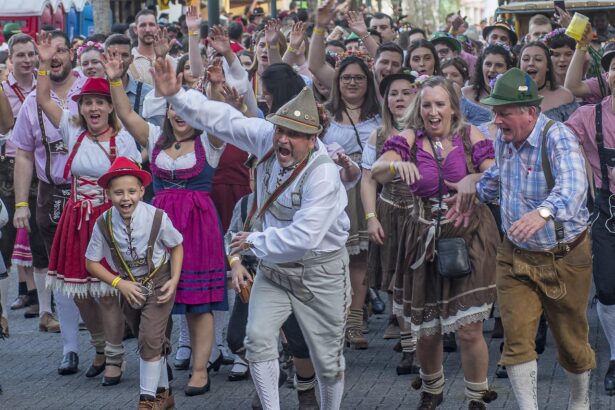 Visitors at Munich Oktoberfest fanning themselves in crowded tent during record heat