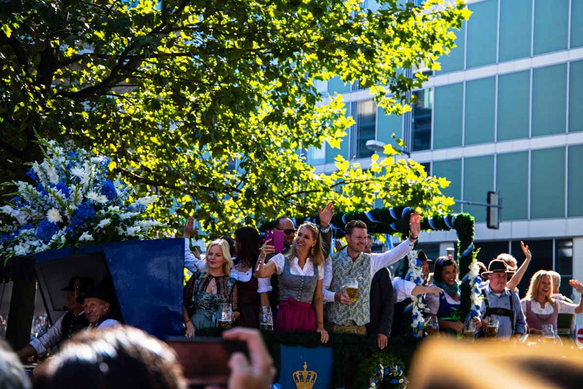 Oktoberfest visitors enjoying beer in a sunny outdoor garden in Munich