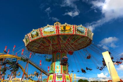 Families with children riding attractions at Oktoberfest in Munich on family day