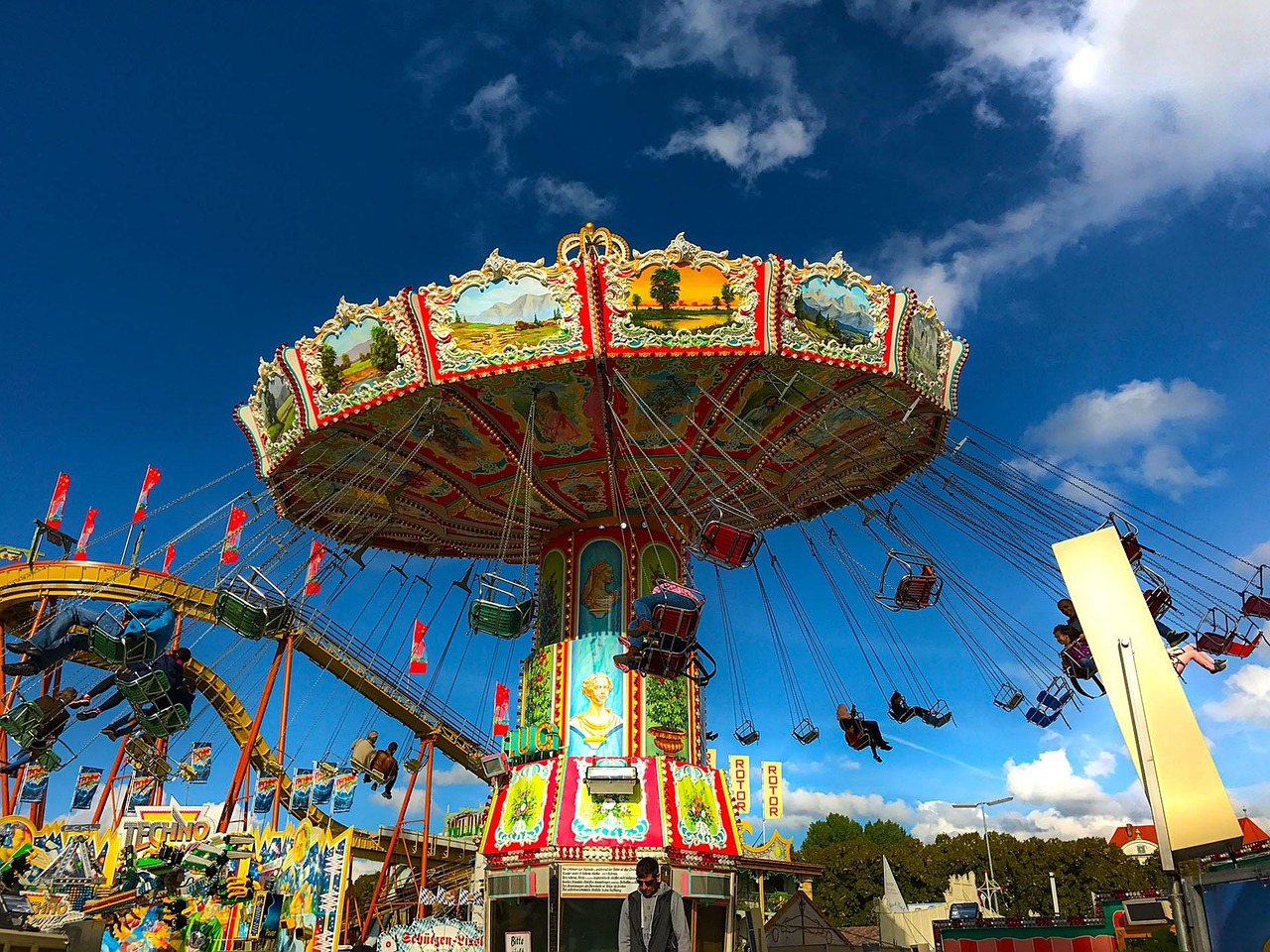 Families with children riding attractions at Oktoberfest in Munich on family day
