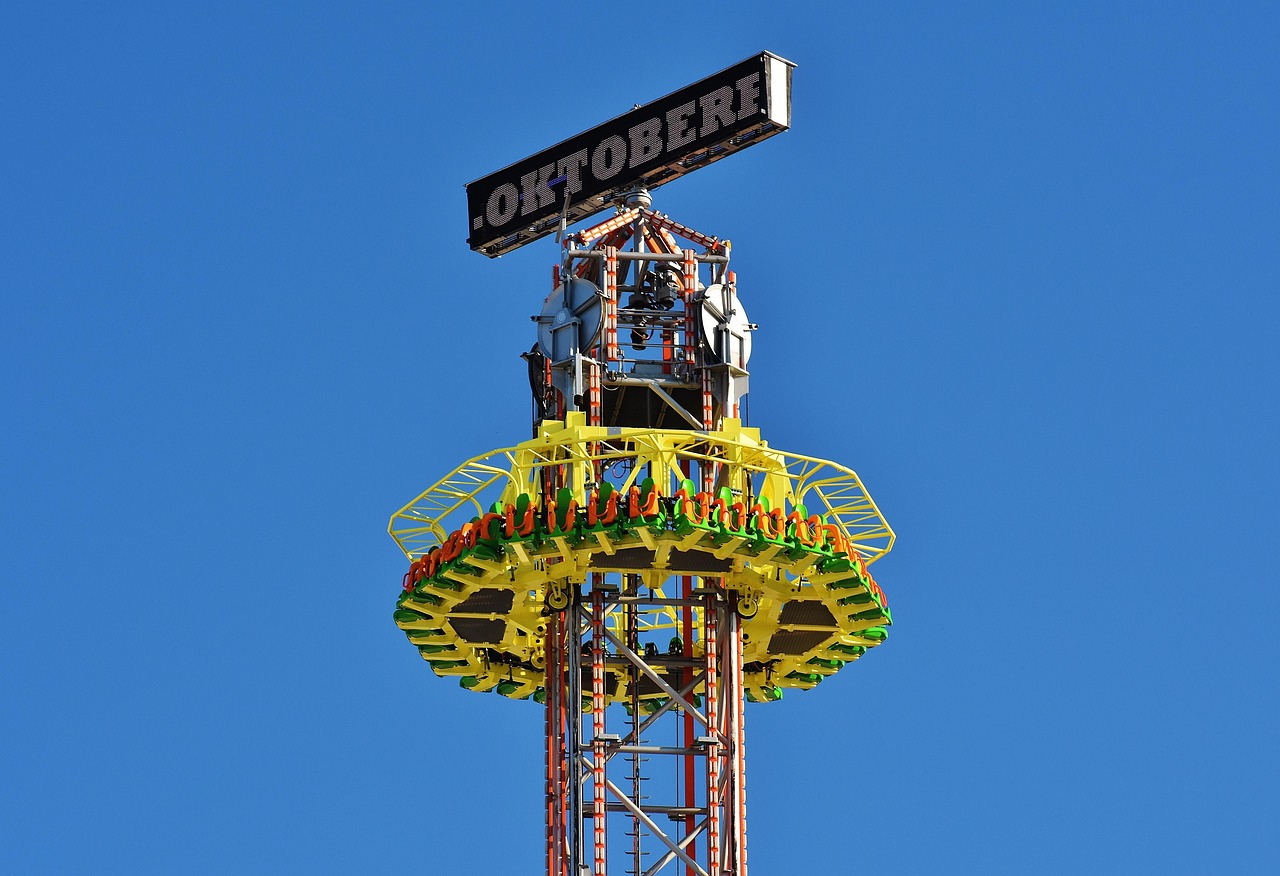 Jules Verne Tower swing carousel at Oktoberfest in Munich lit up at night