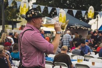 Guests enjoying food and drinks inside a decorated Oktoberfest tent in Munich