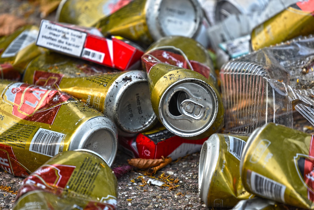 Street near Oktoberfest grounds in Munich with bottles and trash on sidewalk
