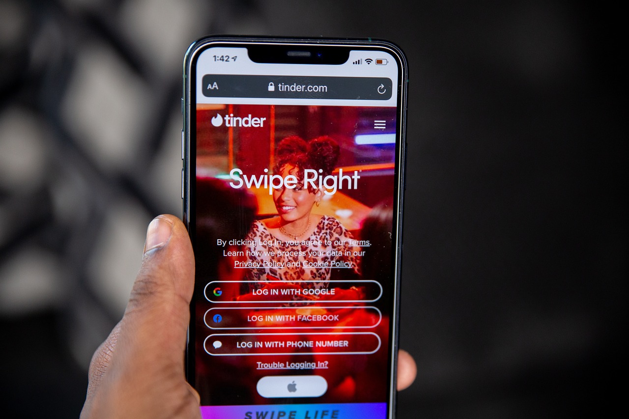 Smartphone showing Tinder app next to euro banknotes symbolizing romance scam
