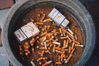 Discarded cigarette filters on the street representing environmental pollution