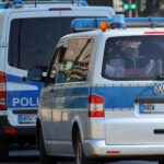 Police vehicles and officers outside Frankfurt police station during misconduct investigation
