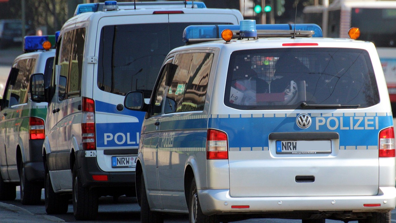 Police vehicles and officers outside Frankfurt police station during misconduct investigation