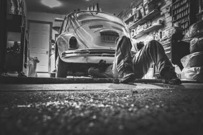 Mechanic in German workshop repairing a car engine