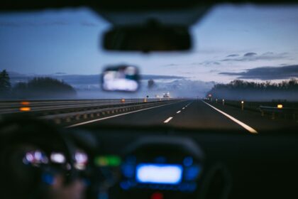 Car driving on a German autobahn at sunrise representing 2026 mobility changes