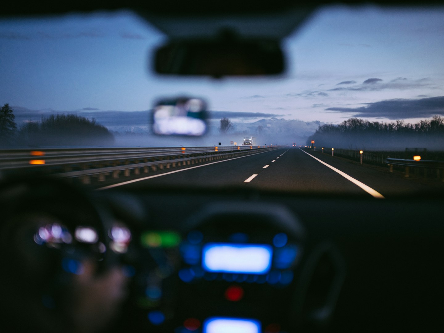Car driving on a German autobahn at sunrise representing 2026 mobility changes