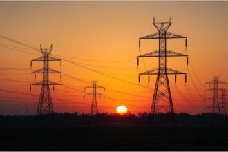ower transmission lines in Germany representing electricity grid fee reductions in 2026