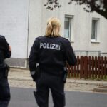 Police vehicles outside a residential building in Herdecke after knife attack on mayor
