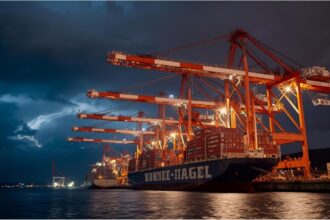 Kühne+Nagel shipping containers at a port during slowdown caused by U.S. trade tensions
