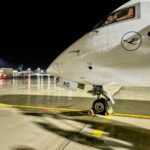 Munich Airport terminal at night after drone disruptions with stranded passengers