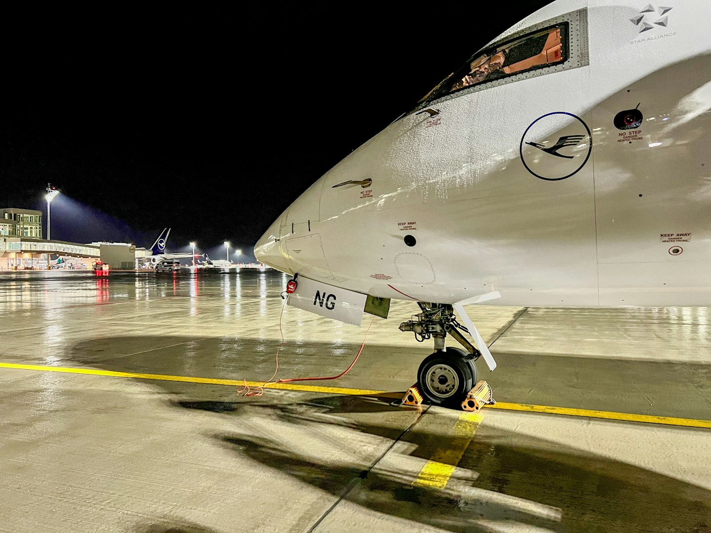 Munich Airport terminal at night after drone disruptions with stranded passengers