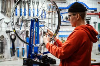 Mechanic checking a bicycle at a free safety event in Munich