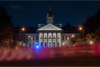 Police and paramedics at a Munich university building after a student’s fall from the second floor.