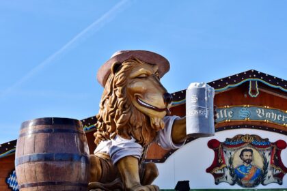 Visitors at Munich Oktoberfest holding soft drinks inside a beer tent