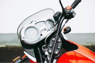 Pope Francis sits on a white BMW R18 motorcycle signed for charity auction