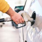 TÜV engineer checking a fuel dispenser at a German petrol station