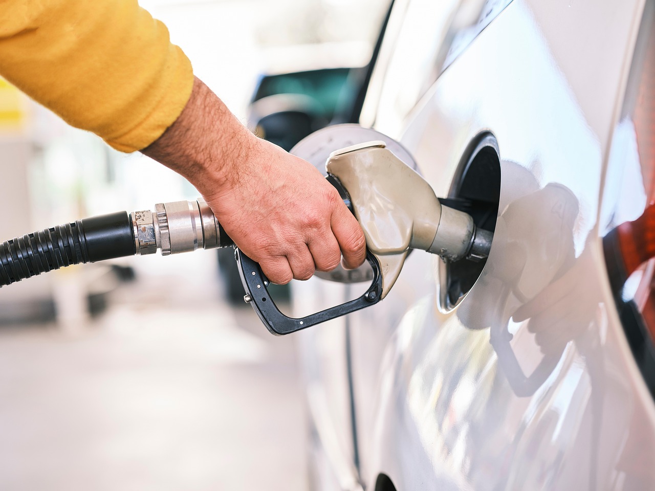 TÜV engineer checking a fuel dispenser at a German petrol station