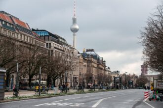 Aerial view of a busy German city road with cars and pedestrians highlighting traffic density.