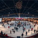 Visitors enjoy Munich Airport’s 25th Christmas market with an ice rink and festive lights under Europe’s largest covered plaza
