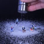 Winter service vehicles in Munich clearing a snow-covered street during early morning hours.