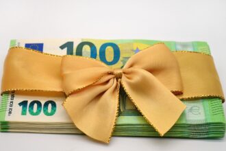 Employees in Germany reviewing payroll documents related to Christmas bonus payments.